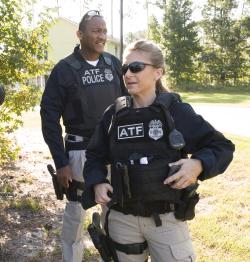 A female and male special agent standing outside an operation