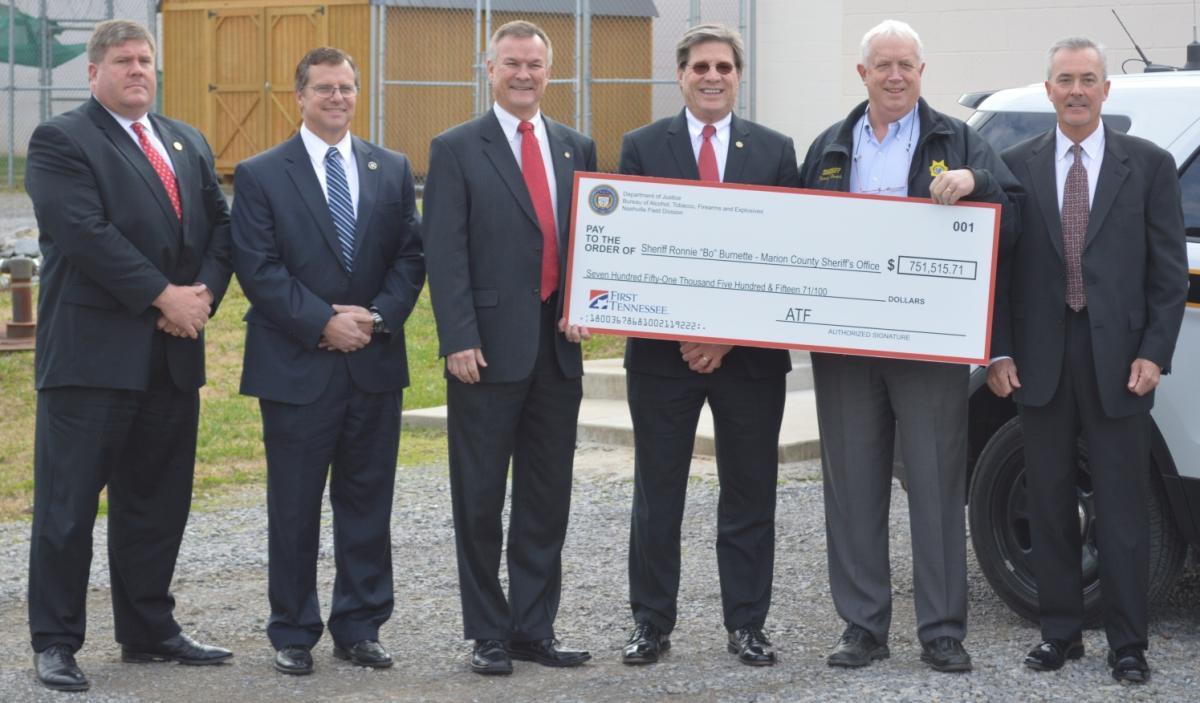 Photo of federal law enforcement representatives presenting a check to Marion County Sheriff's Department for forfeited funds from a marijuana trafficking case. 