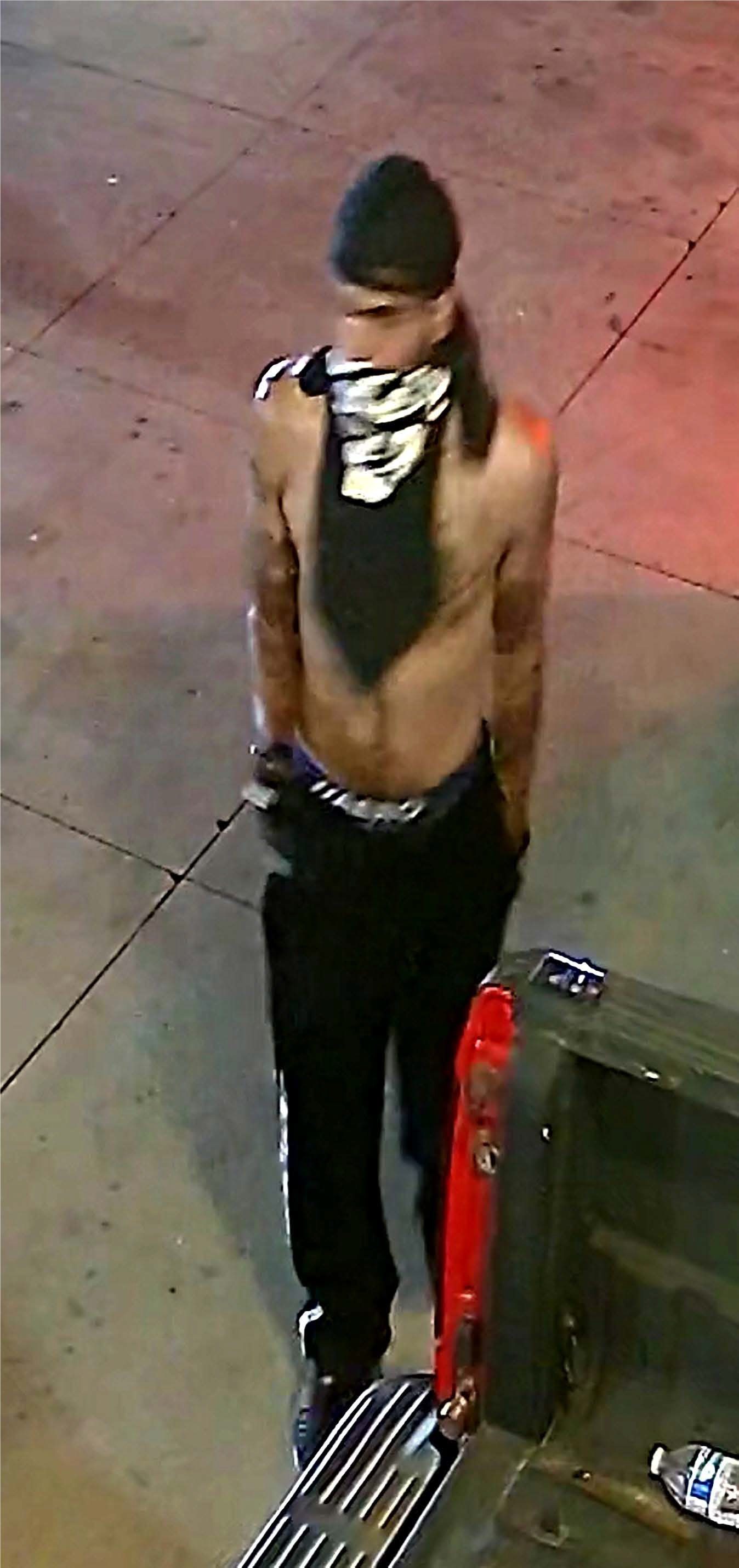 Male with no shirt, black pants, black hat and black t-shirt tied around the lower half of his face, identified as UNSUB #30.