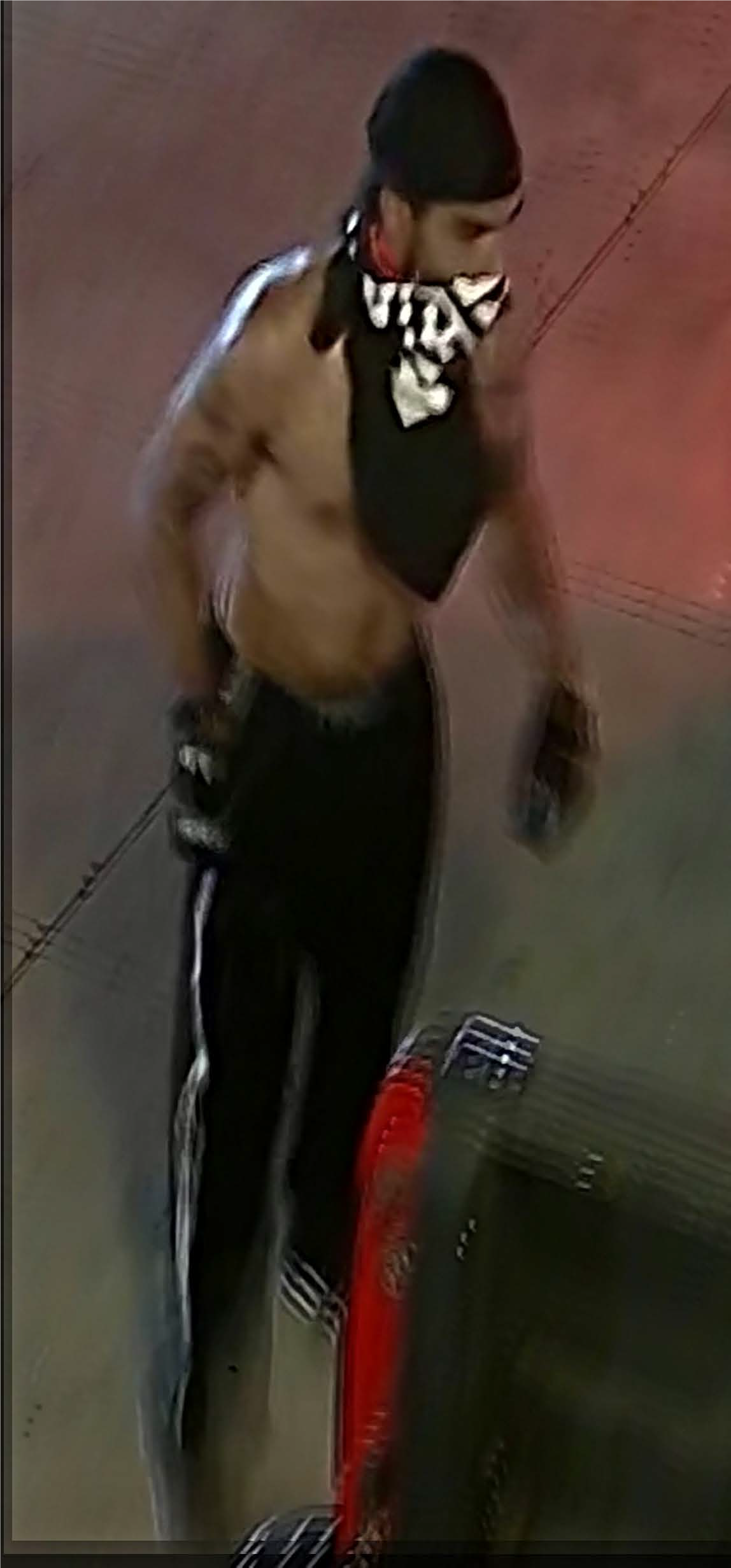 Male with no shirt, black pants, black hat and black t-shirt tied around the lower half of his face, identified as UNSUB #30.