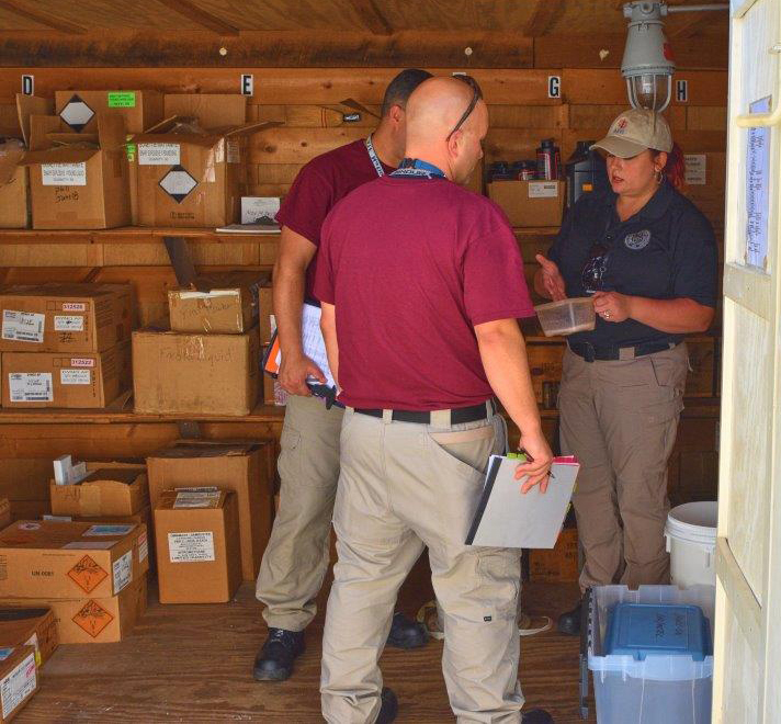 An industry operations investigator inspects a business inventory during IOI basic training
