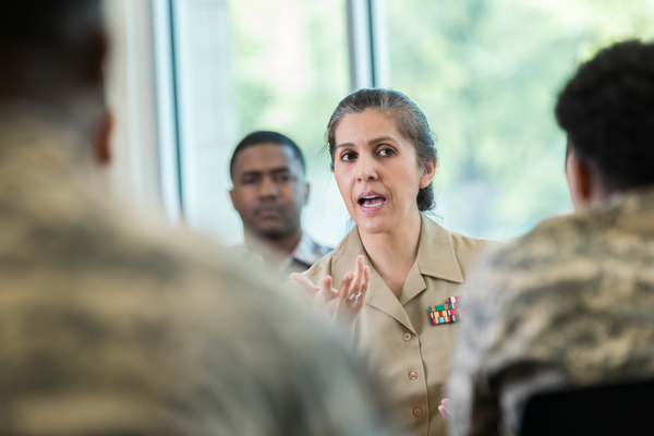 Female military member talking to troops