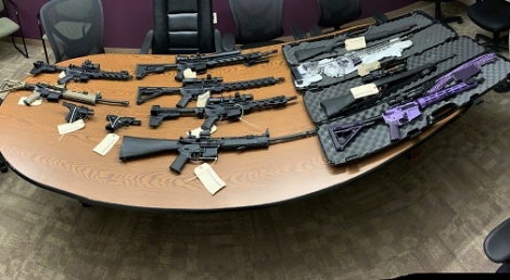 Rifles and handguns on a table