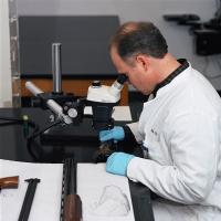 An examiner analyzes a firearm in the National Laboratory Center in Atlanta.