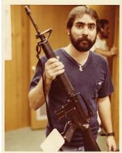 Imagen de Ariel Rios sosteniendo un arma de fuego incautada.