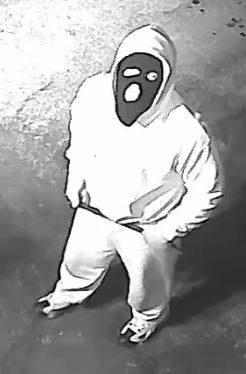 Image of suspect 3 wearing a light hoodie, sweat pants, and a dark colored face mask.