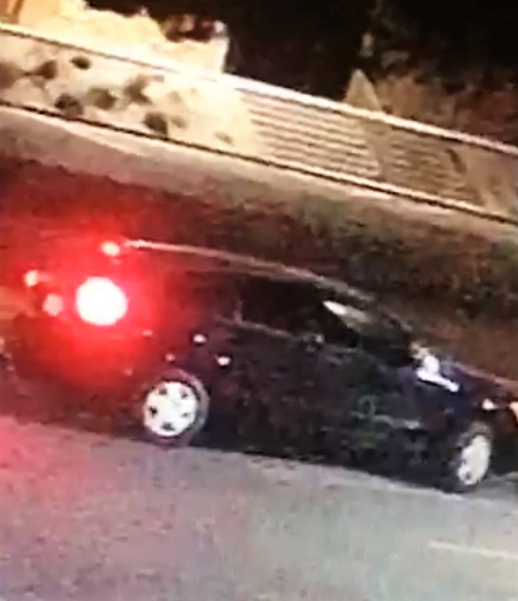 Image of the vehicle, black sedan with tinted windows, used during the theft. 