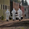 Technicians walking towards a building