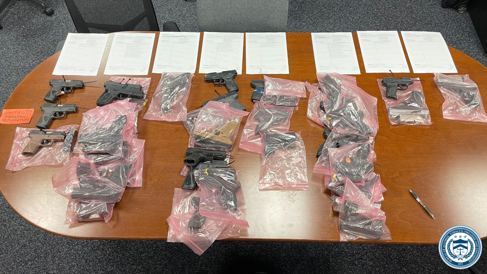 Several firearms laid out on a table