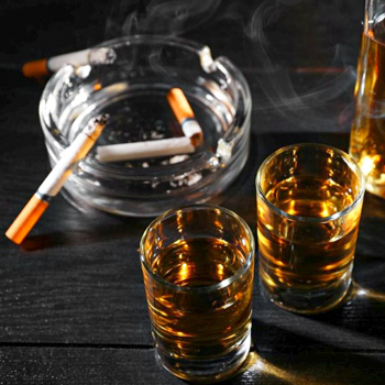 Tobacco cigarettes and glasses of alcohol