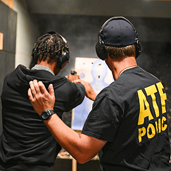 An ATF agent assists an individual using a firearm