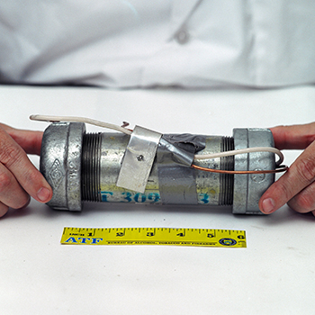 An explosive device next to a six-inch ATF ruler