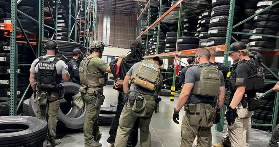 An individual arrested during Operation Show Me Justice An individual being arrested by various law enforcement members.
