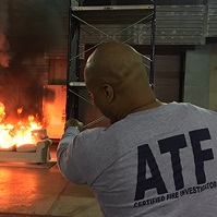 ATF fire researcher watch flames engulf a couch. 