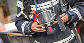 Image of a fire investigator holding equipment