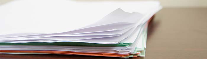 Image of a pile of papers on a desk