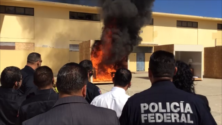 Image of the Mexican Federal police watching a test burn