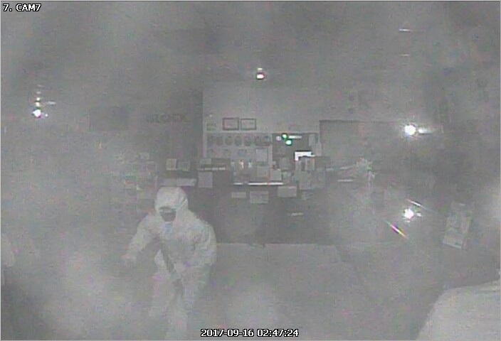 Person of interest seen wearing all white clothing in the midst of the robbery. 