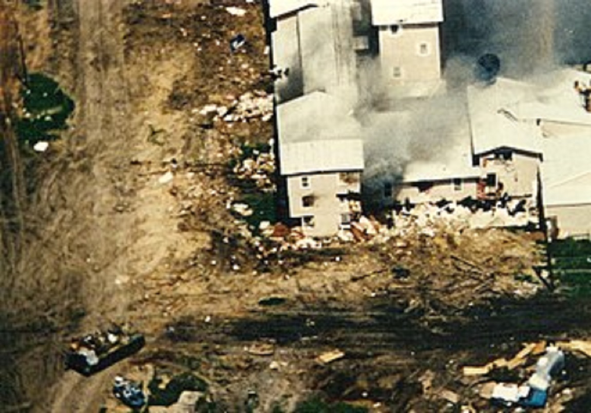Aerial view of the Mount Carmel compound with smoke coming out of the windows.