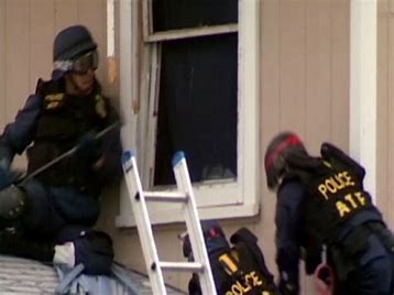 Image of ATF agents standing by an open window