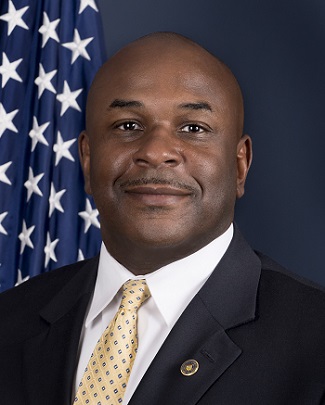 Image of a headshot of Special Agent in Charge Marcus Watson in front of the American flag.