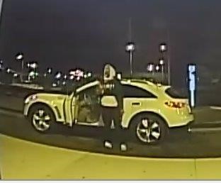 Person of interest in hoodie in front of yellow sports car.