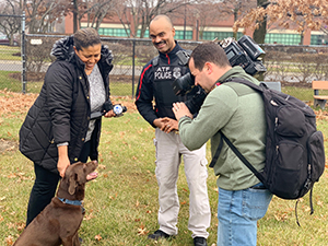 Special Agent Canine Handler George Goodman and K-9 Bonny are interviewed by the press
