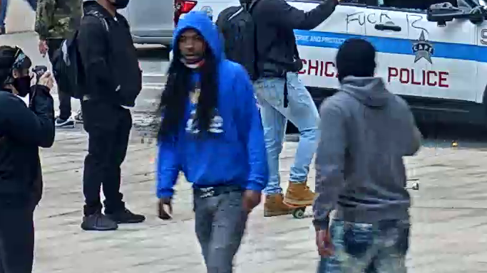 Suspect 1 is a male with long hair in a blue hoodie and jeans.