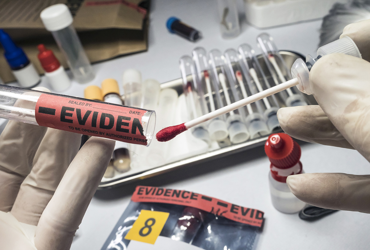 A forensics specialist tests evidence in the lab