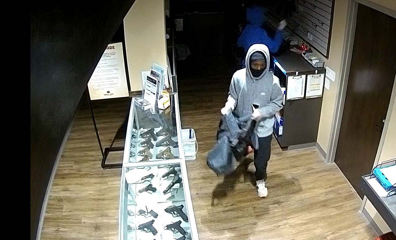 Two suspects inside the store grabbing firearms