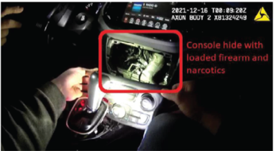 Items hidden within the dashboard of a vehicle. Descriptive text overlays the image which states, "Console hide with loaded firearm and narcotics."
