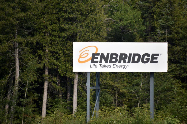 A sign with the words "Enbridge - Life Takes Energy."