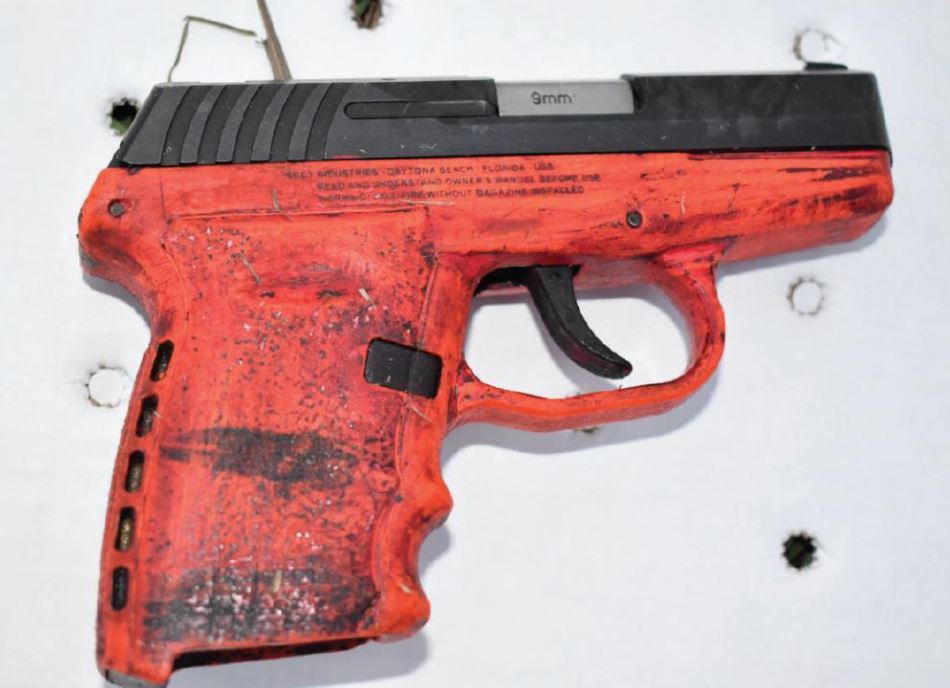 A firearm with a red stock and a dark colored slide.