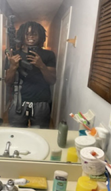 A person taking a photo in front of a mirror.
