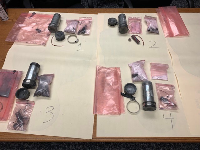Four homemade pipe bombs displayed as evidence