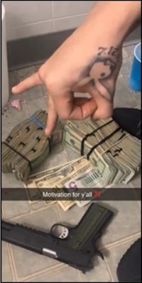 Photo of a hand above a large sum of rubber banded money and a gun, with the word Motivationfor y'all typed across the image.