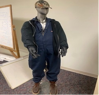 Photo of the articles of clothing, multiple masks, the firearm, handwritten notes, and brown boots associated with the robberies that was seized by law enforcement.