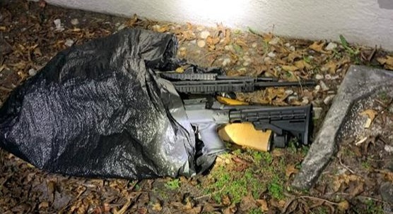 Firearms lying on the ground in a plastic bag