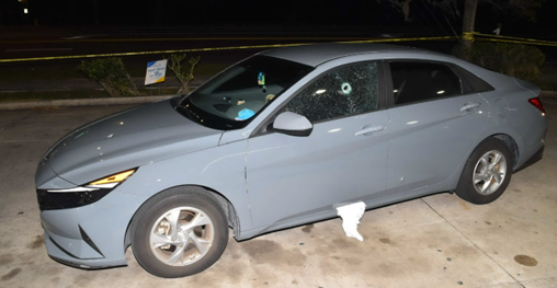 Car with bullet hole in driver window