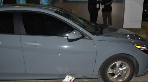 Car with bullet hole in passenger door