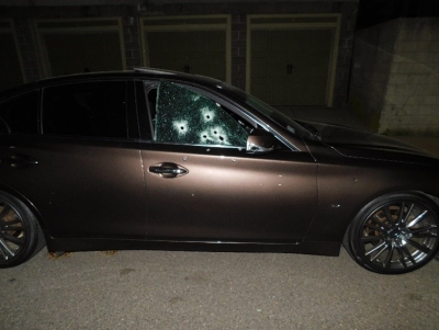 Car with passenger window having multiple bullet holes