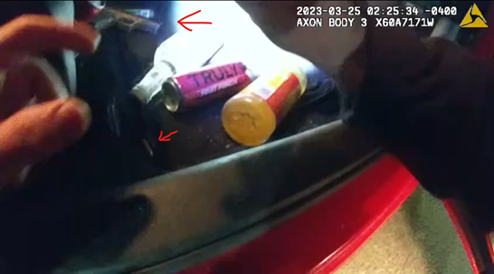 Body camera footage showing a gun and shell casings lying in the trunk