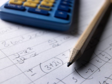 Picture of a pencil and calculator.