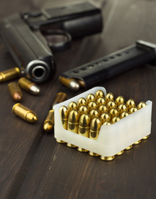 Handgun with a box of ammunition on a wooden table