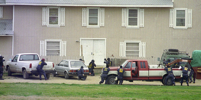 ATF agents line up behind cars and trailers during the opening moments of the raid