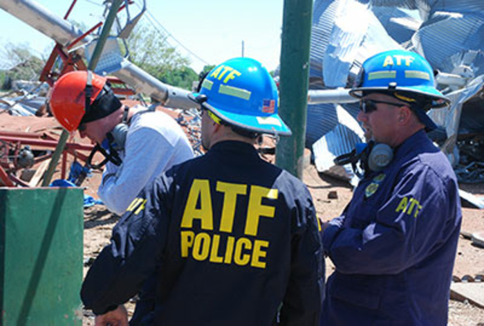 Three agents talking during the investigation