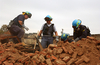 Four agents go through remnants of an explosion
