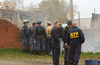 ATF agents having a discussion during an investigation at an undisclosed area