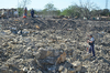 Agent standing in debris will a shovel in their hand