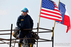 Agent standing next to an American flag